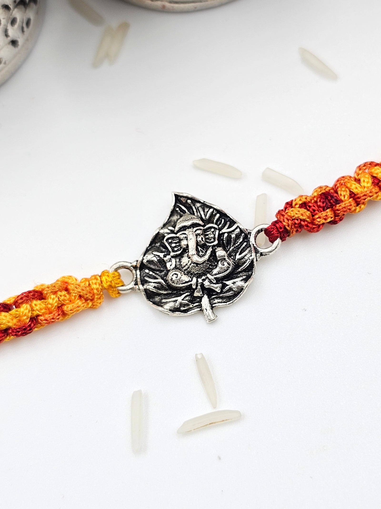 Ganesha with leaf  Silver Rakhi by GinniSilver